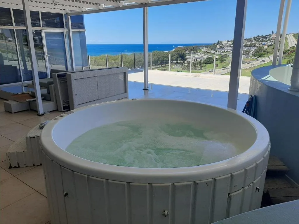 Hot tub on covered deck with panoramic ocean and coastal views
