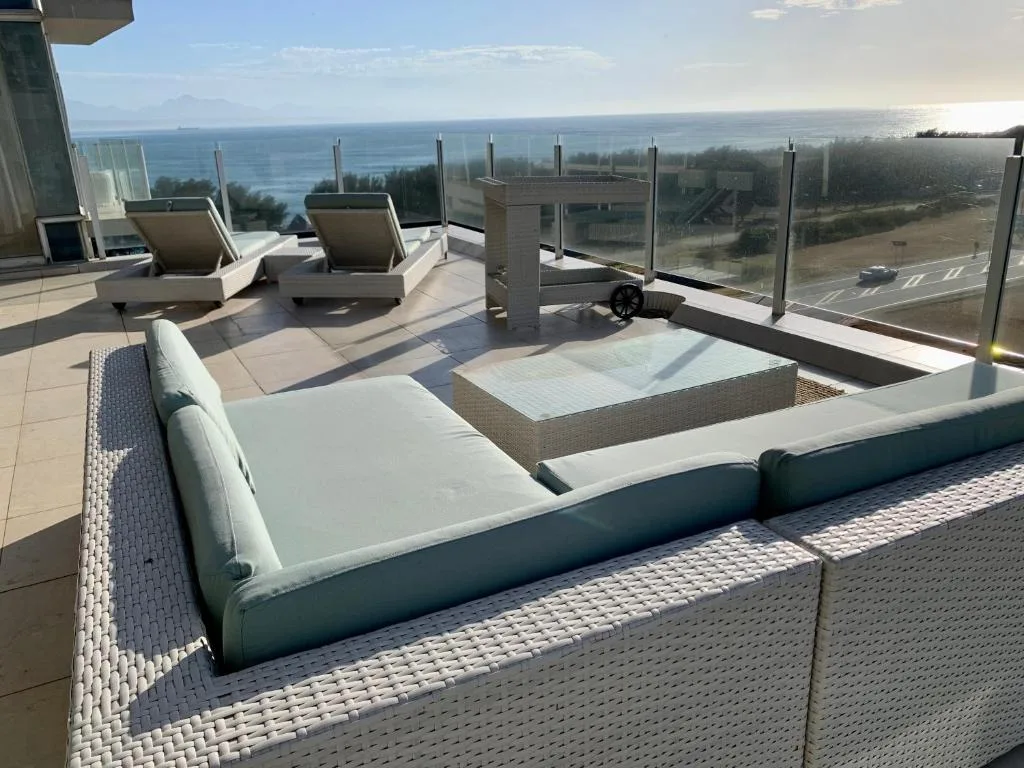 Rooftop terrace with loungers and ocean view over Mossel Bay