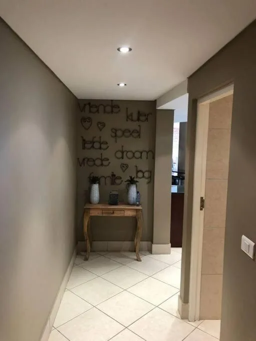 Hallway entryway with console table, inspirational wall art, and recessed lighting