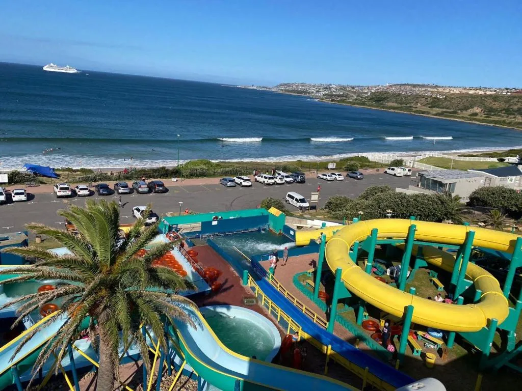 Scenic coastal view with beach, waves, and ocean from property overlook
