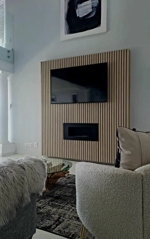 Modern living room with TV wall feature and comfortable seating arrangements
