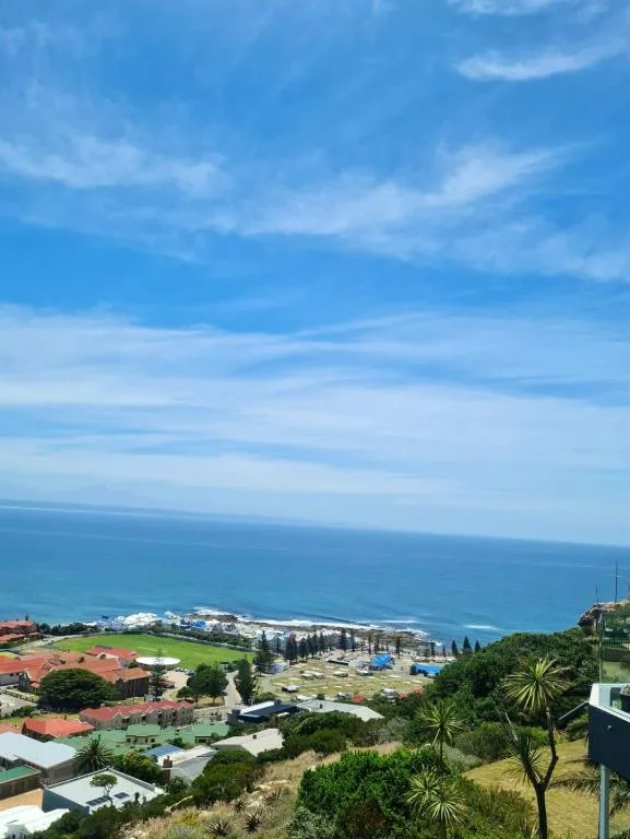 Panoramic coastal view overlooking Mossel Bay with ocean, beach, and town below