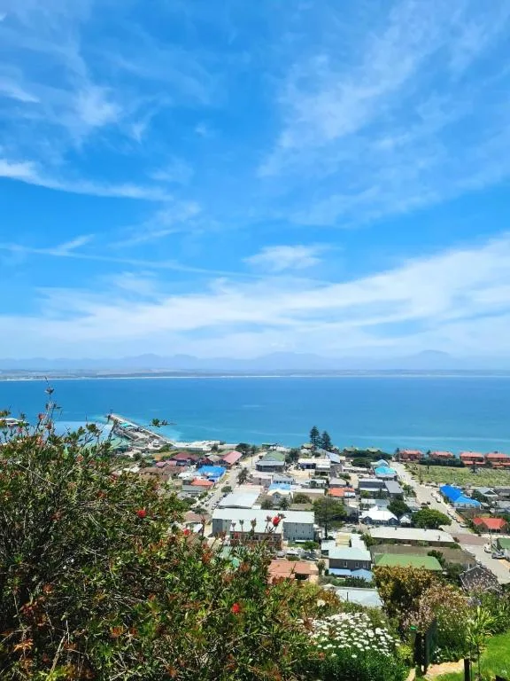 Scenic coastal town view overlooking turquoise ocean and distant mountains
