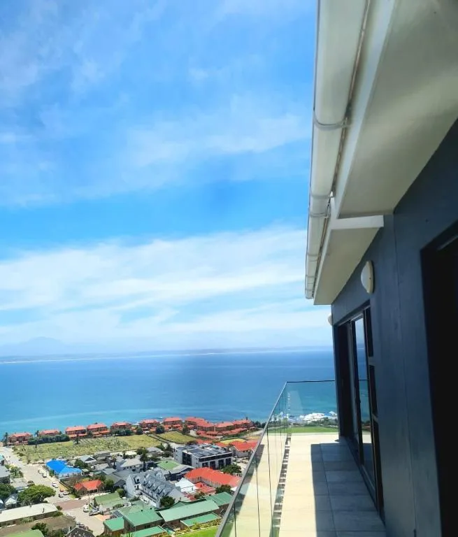 Panoramic ocean and coastal landscape view from elevated apartment balcony