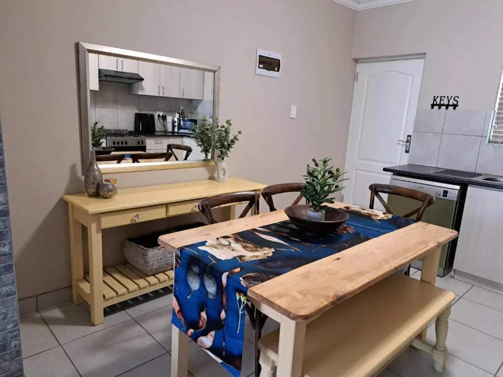 Dining area with wooden table, bench seating, and open kitchen view