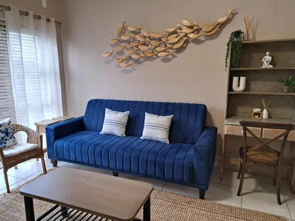 Contemporary lounge with blue upholstered sofa and decorative wall art