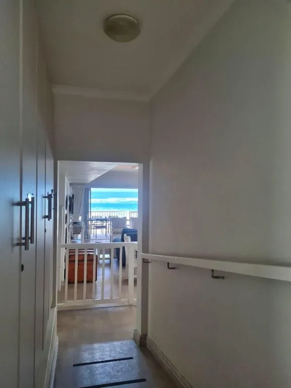 Ocean view through hallway and open glass doors to sea