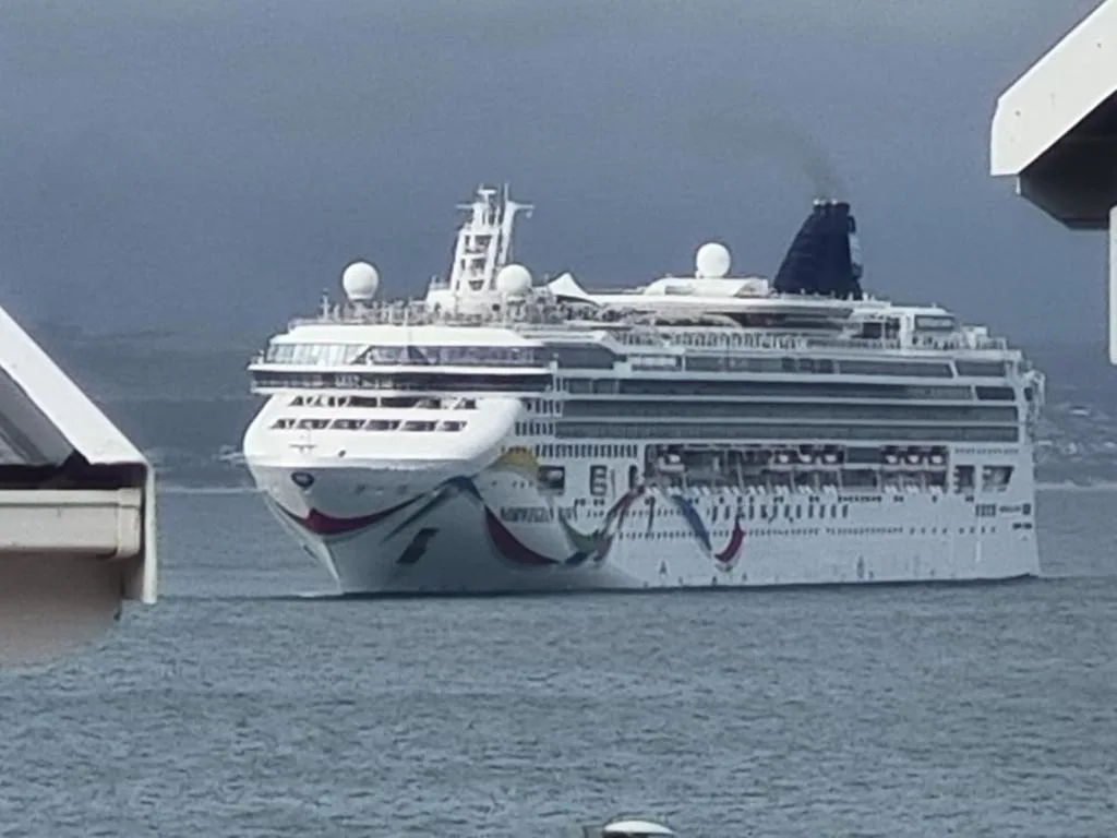 Large cruise ship anchored in Mossel Bay waters on blue ocean