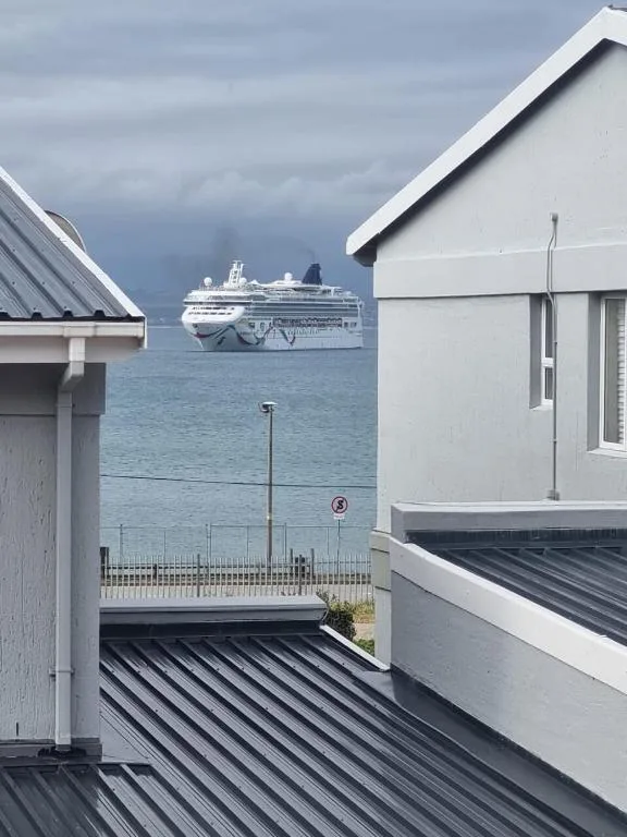 Cruise ship anchored in bay visible from property deck
