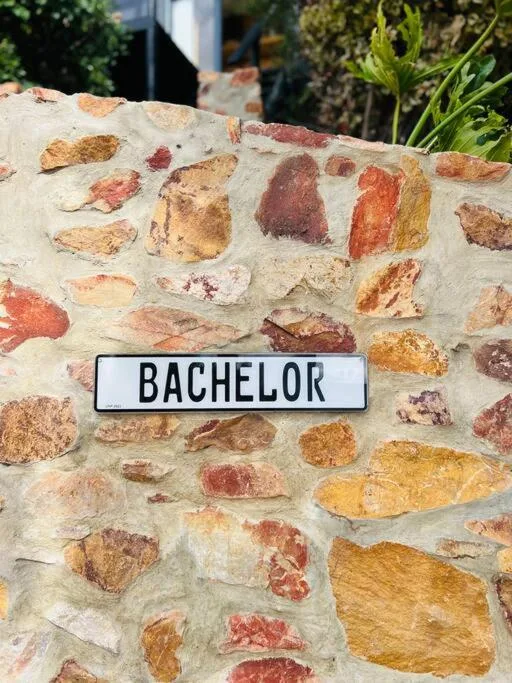 Colorful brick wall with Bachelor property name sign