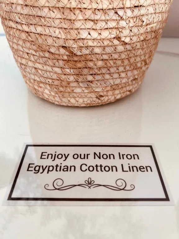 Woven natural basket with Egyptian cotton linen amenity label