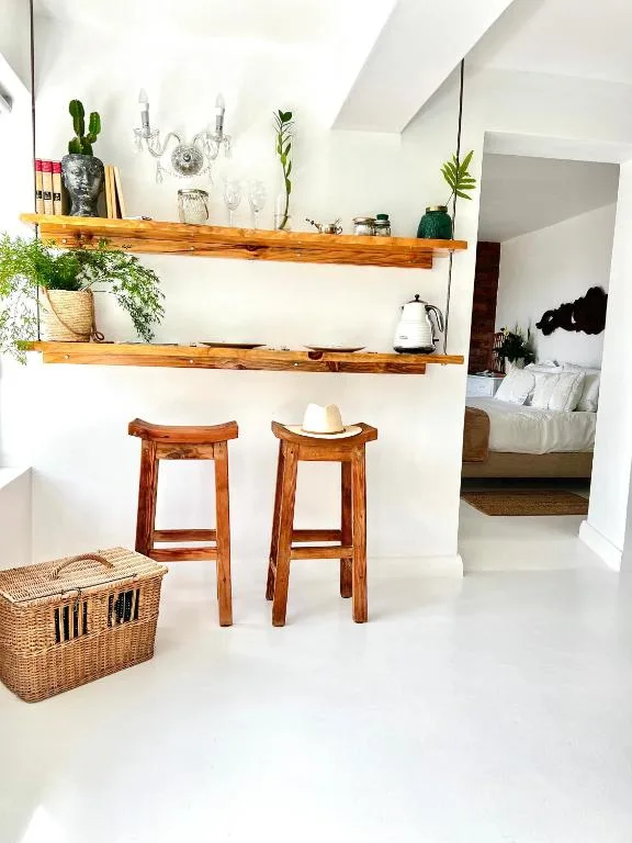 Wooden shelves with plants, glassware, and decorative items in bright interior