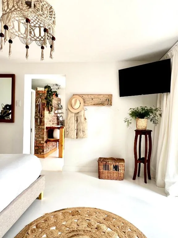 Bright lounge with TV, macramé chandelier, and boho decor