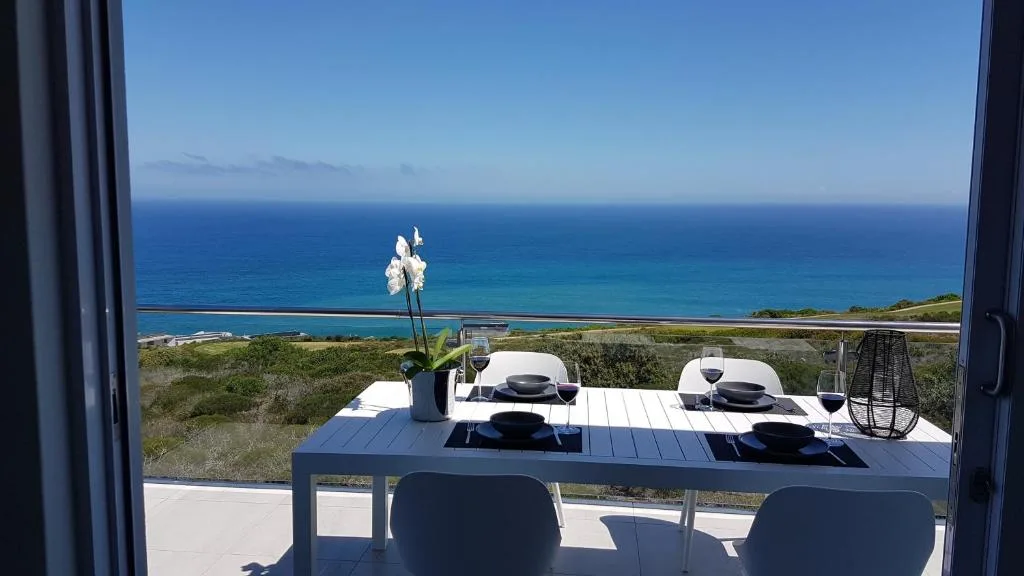 Stunning ocean and coastline vista from elevated dining deck area