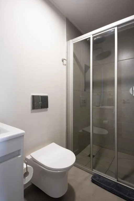 Modern bathroom with white toilet and glass shower enclosure