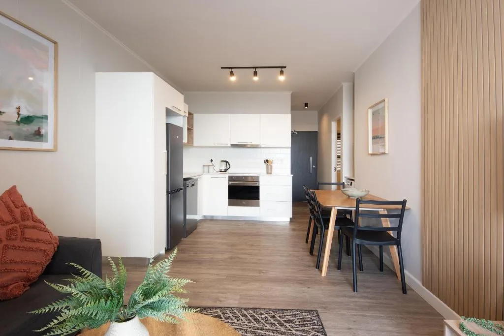 Open-plan living space with lounge, kitchen, and dining area combined