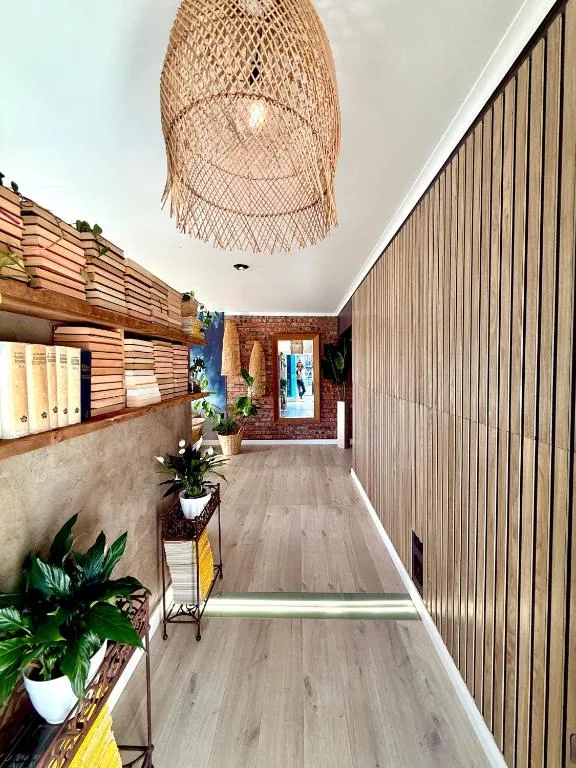 Modern hallway with woven pendant light and potted plants