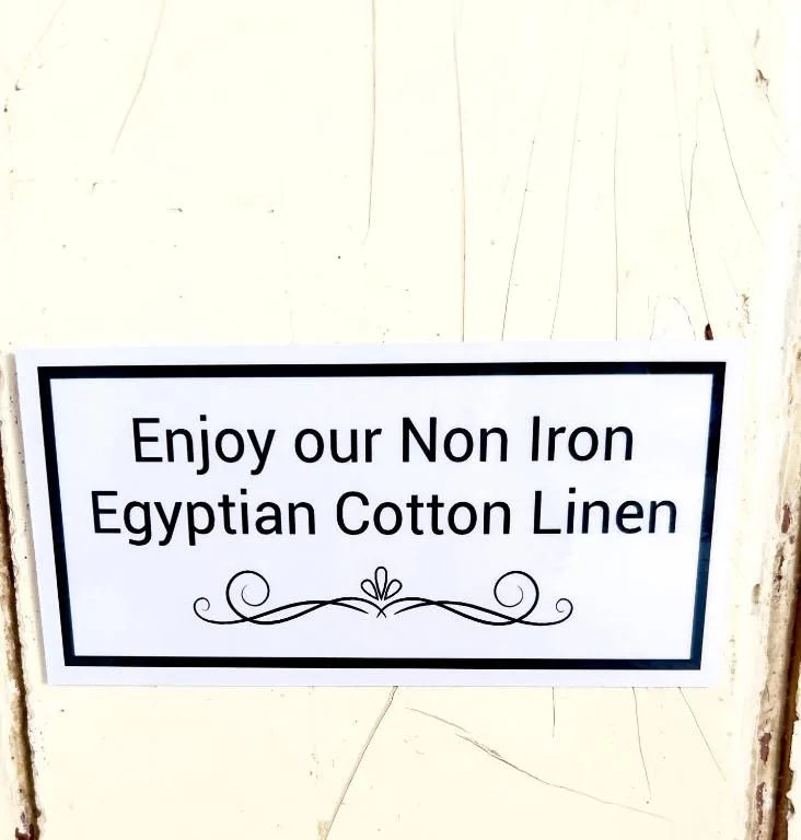 Sign advertising non-iron Egyptian cotton linen bedding amenity