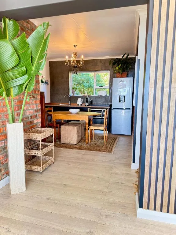 Modern kitchen with stainless steel refrigerator and wooden countertop dining area