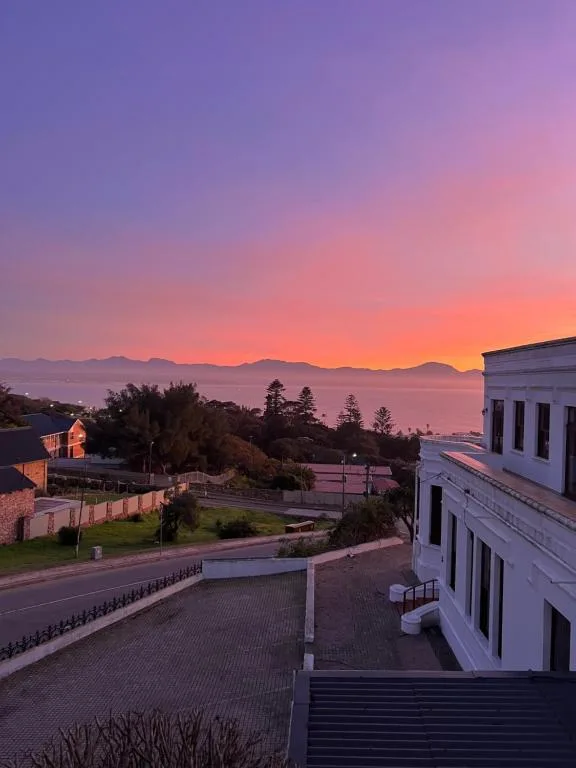 Stunning sunset over mountains and ocean from property viewpoint
