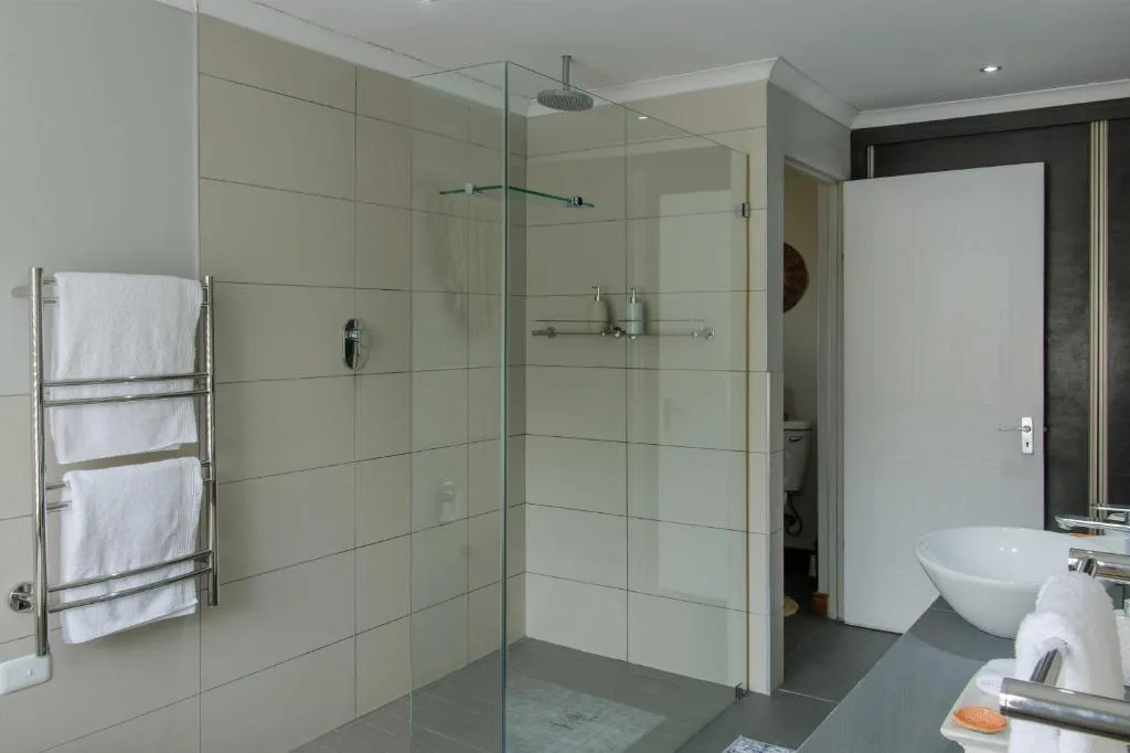Modern bathroom with large glass shower enclosure and rainfall showerhead