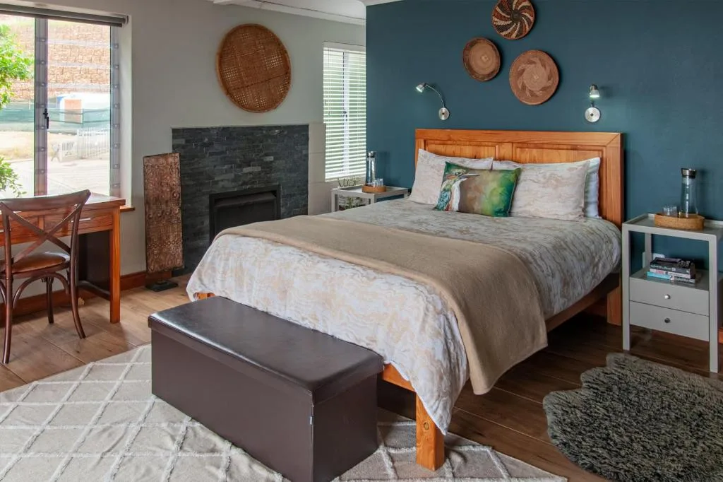 Spacious bedroom with wooden bed frame and teal accent wall