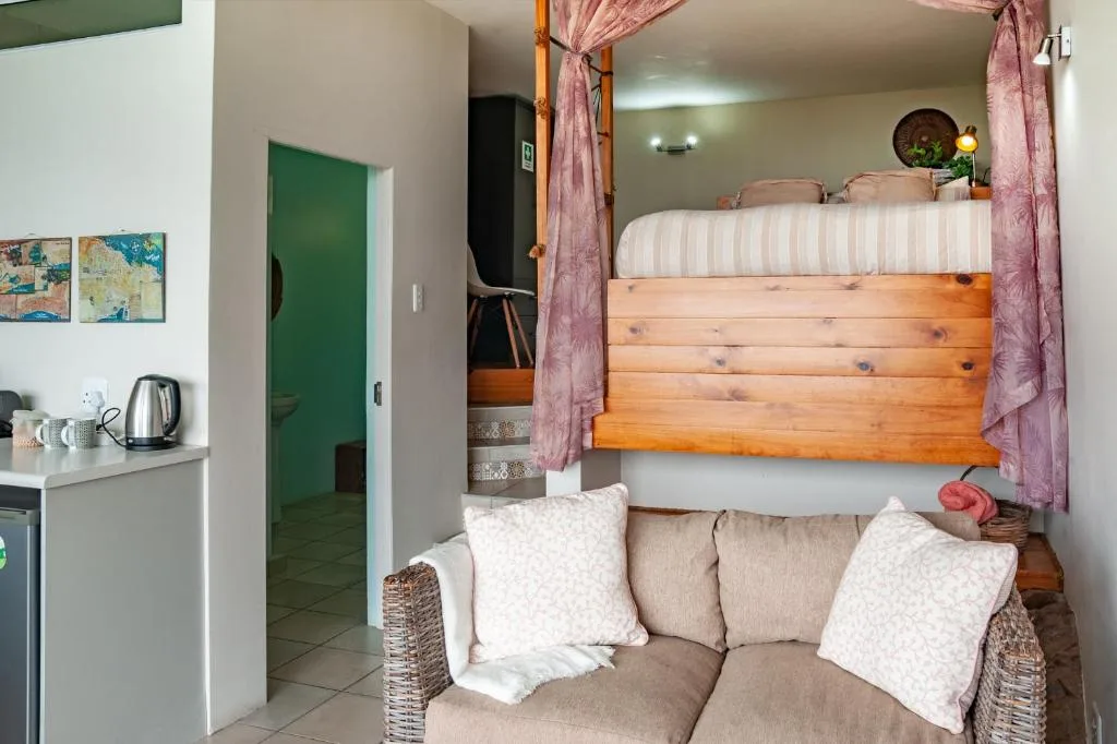 Wooden bunk bed with white striped mattress and pink curtains in cozy bedroom