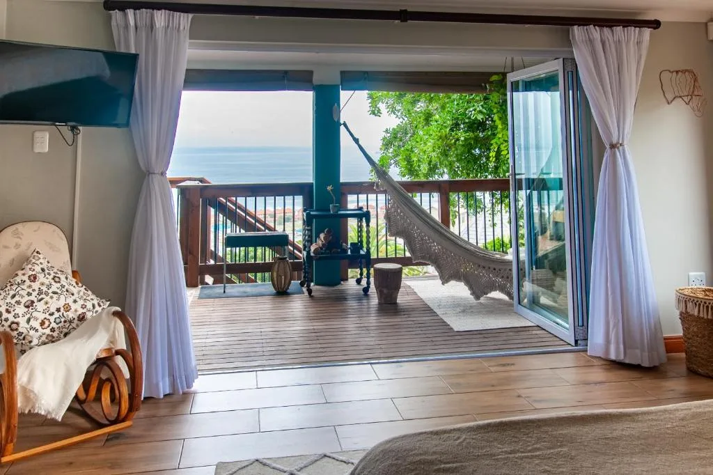 Ocean and lagoon views framed through open deck doors and windows