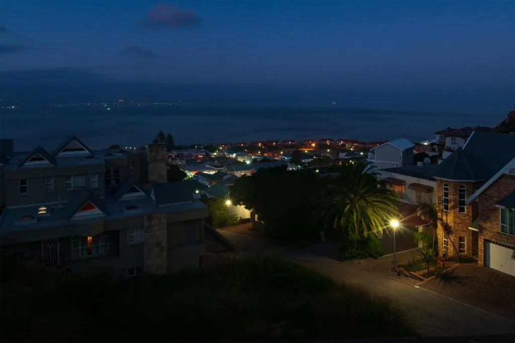 Twilight view of Mossel Bay town lights and coastal landscape from property