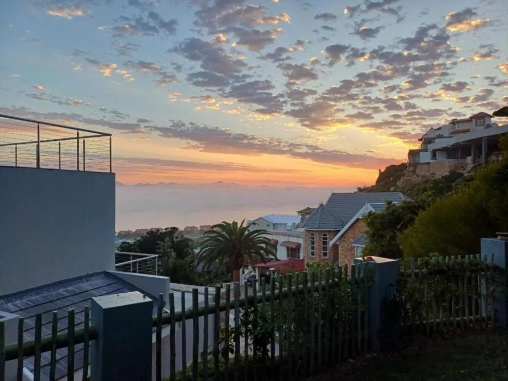 Sunset over Mossel Bay with golden clouds and coastal landscape