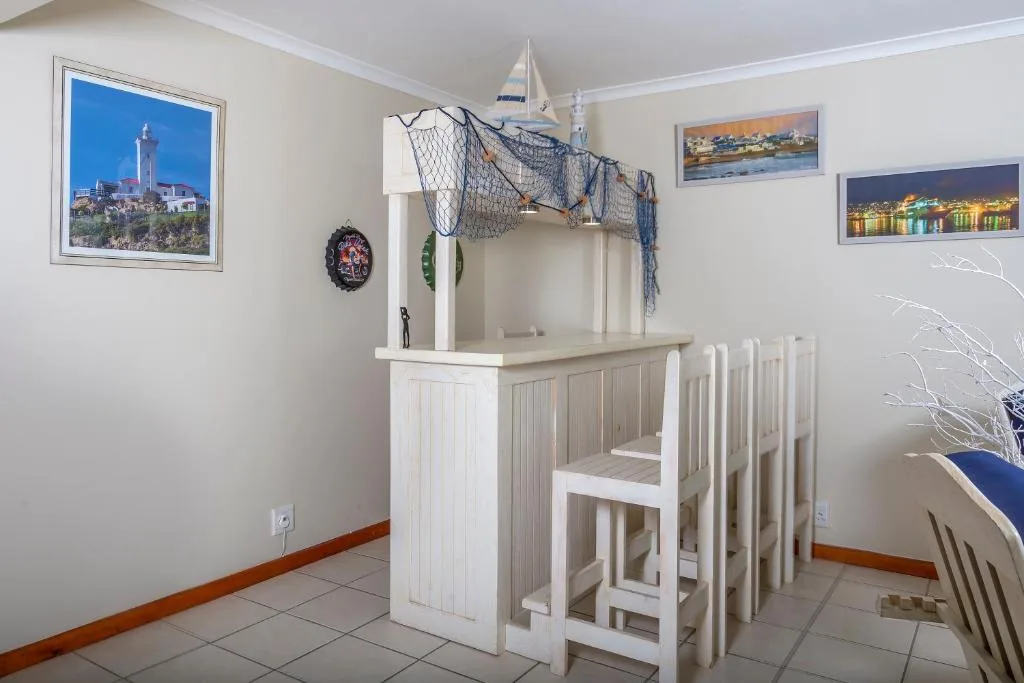 Nautical-themed bar counter with fishing net and sailboat decor