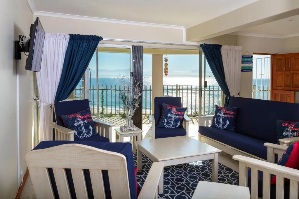 Bright lounge with blue seating and ocean view through large glass doors