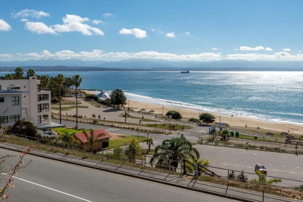 Stunning ocean beach view with mountains and blue sky from property