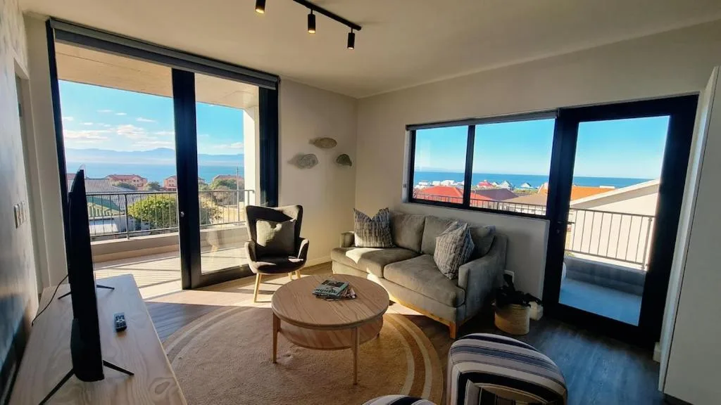Bright lounge with ocean views through large windows and glass doors