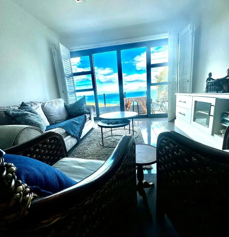 Bright lounge with ocean views through large glass doors and windows