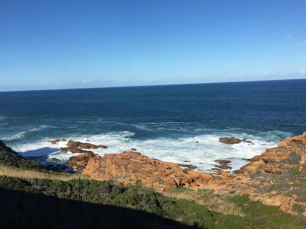 Scenic coastal ocean view with rocky outcrops and breaking waves