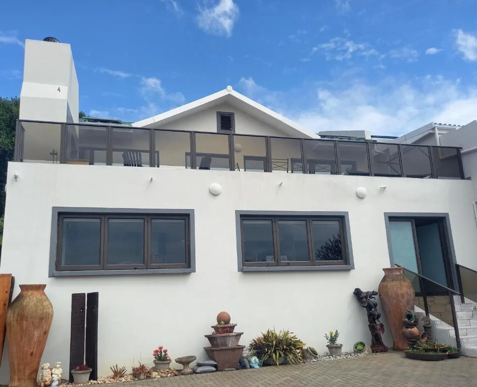 Modern white property with deck overlooking garden route landscape