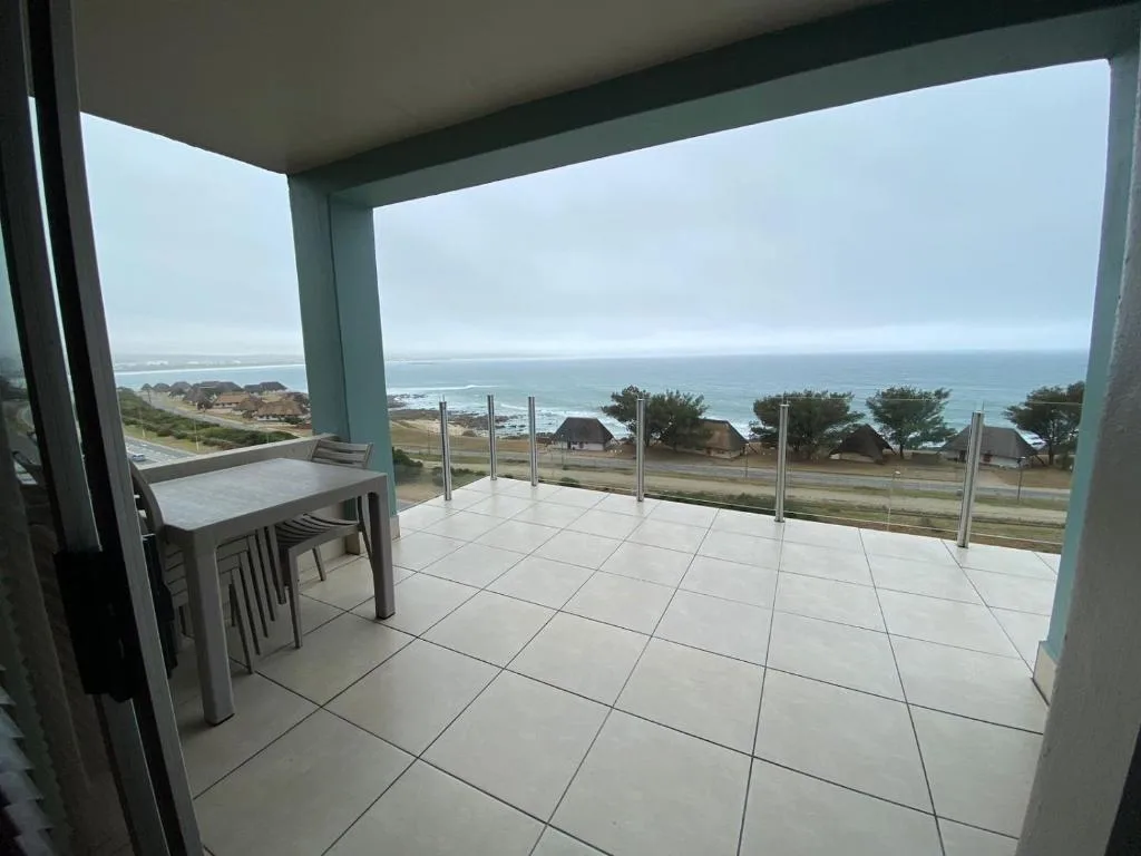 Spacious patio with ocean and coastal village views from glass railing