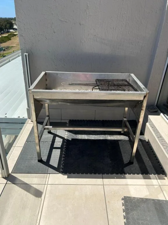 Built-in braai barbecue grill on outdoor patio deck area