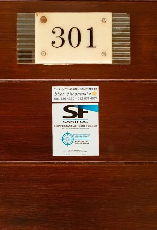 Property number 301 on wooden door with sanitization certificate below