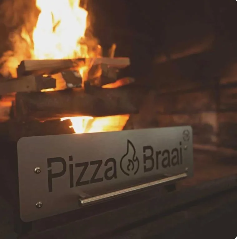 Pizza Braai wood-fired oven with flames, outdoor cooking amenity