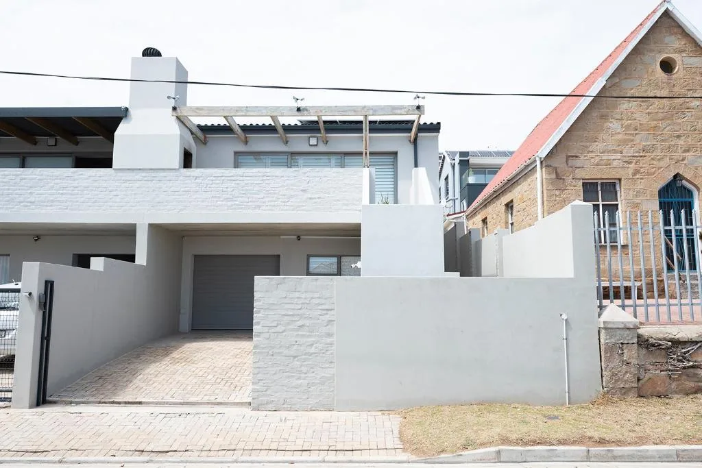Modern white two-story holiday home with driveway and garage entrance