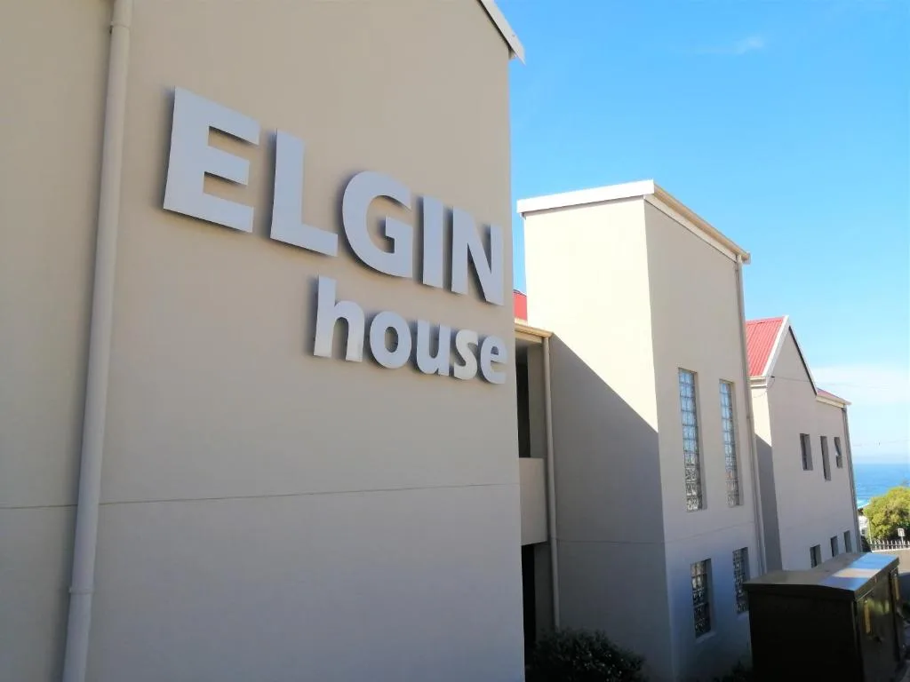 Modern white building facade with Elgin House signage and ocean view