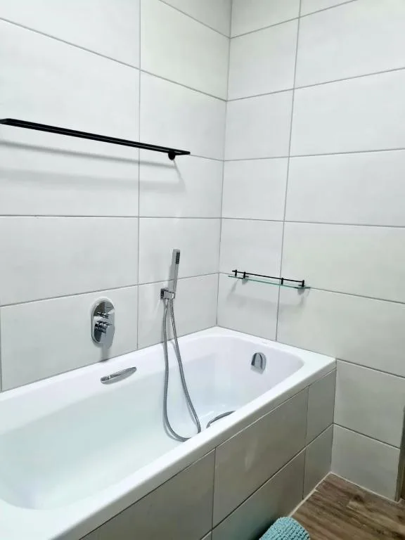 Modern bathroom with white subway tiles, soaking tub, and shower fixtures