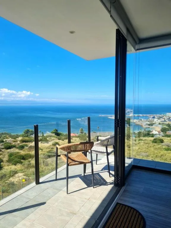 Modern deck with chairs overlooking coastal ocean views and town