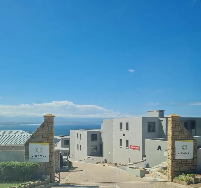 Modern white apartment buildings with ocean view and entrance gates