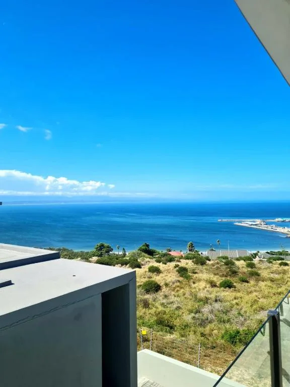 Expansive ocean and coastal town vista from elevated deck position