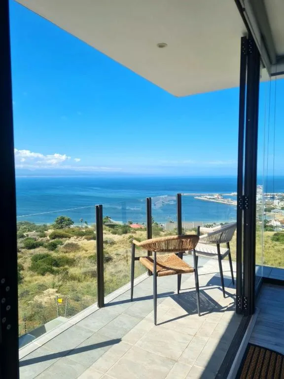 Expansive ocean and coastal landscape vista from elevated deck overlooking Mossel Bay