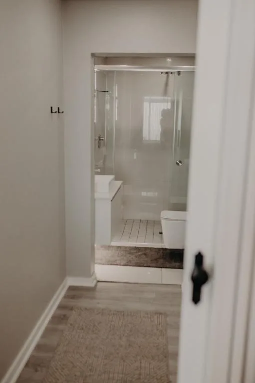 Modern bathroom with glass shower enclosure and white toilet fixtures