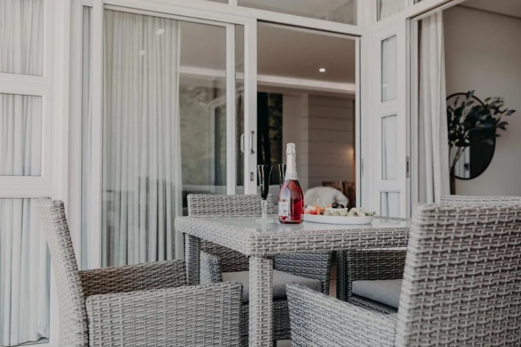 Outdoor patio with wicker furniture and champagne bottle on table